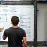 Coach explaining a training plan on a whiteboard